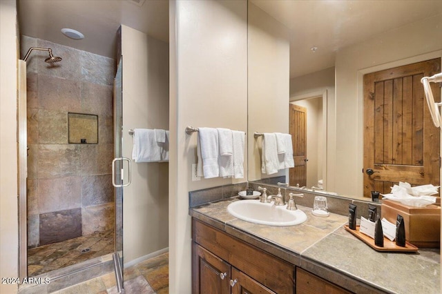 bathroom with vanity and an enclosed shower