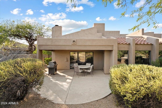 rear view of property featuring a patio area