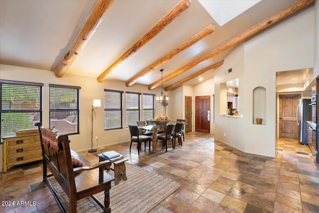 dining area with an inviting chandelier and lofted ceiling with beams