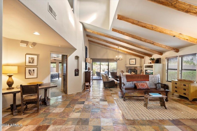 living room with beamed ceiling and high vaulted ceiling