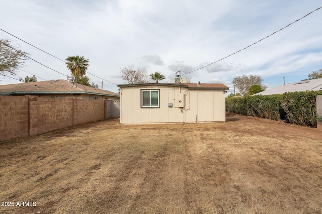 view of outbuilding with an outdoor structure and fence