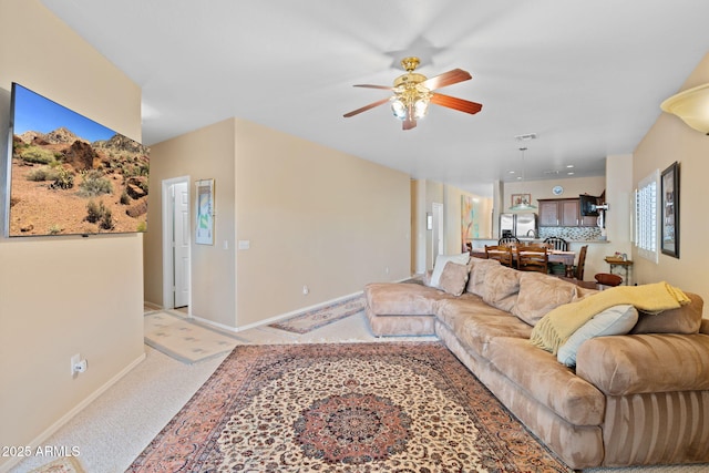 living room with light carpet and ceiling fan