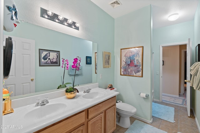 bathroom featuring tile patterned floors, vanity, and toilet