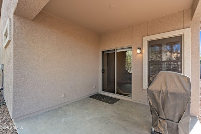 property entrance featuring a patio area