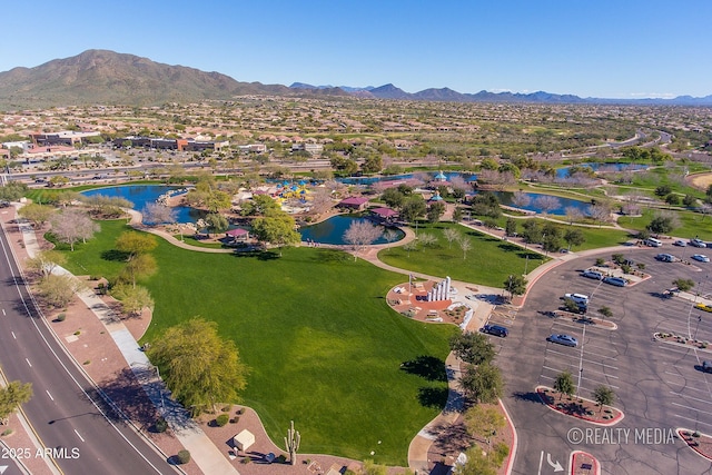 drone / aerial view featuring a water and mountain view