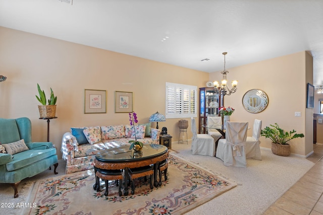 carpeted living room featuring an inviting chandelier