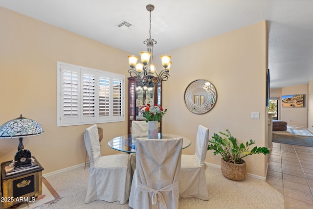 tiled dining room with plenty of natural light and a notable chandelier