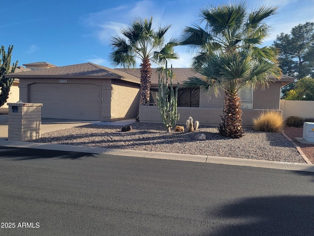 view of front of property with an attached garage, driveway, and stucco siding