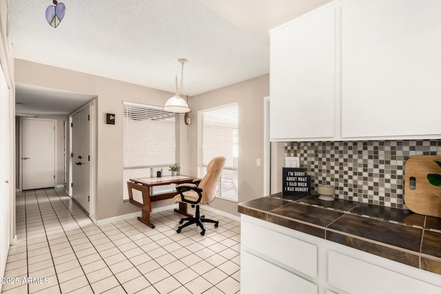 office space with light tile patterned flooring and baseboards