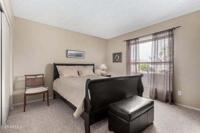 bedroom featuring baseboards and light colored carpet