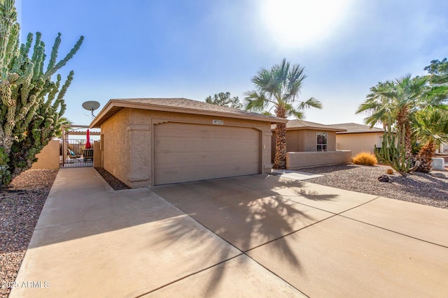 view of front of home with a gate and stucco siding