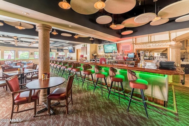 bar featuring a dry bar and ornate columns