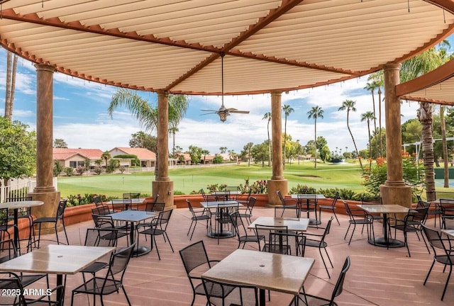 view of patio with view of golf course and outdoor dining space