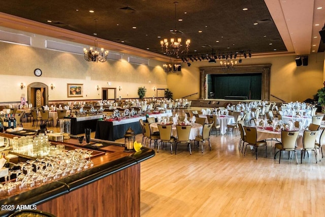 interior space featuring a raised ceiling, wood finished floors, and an inviting chandelier