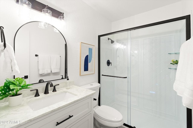 bathroom featuring vanity, toilet, and an enclosed shower