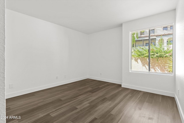 unfurnished room with dark hardwood / wood-style floors