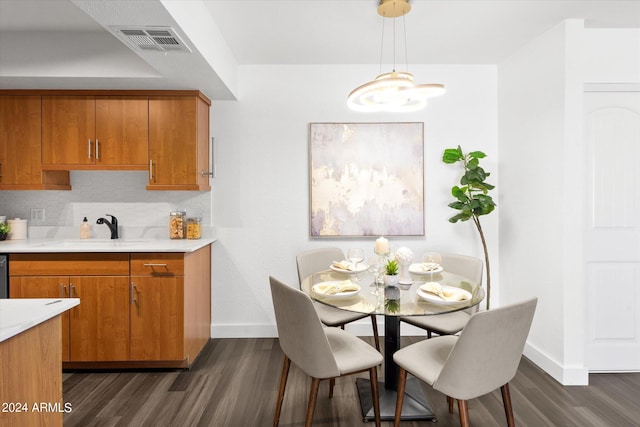 dining space featuring dark hardwood / wood-style flooring and sink