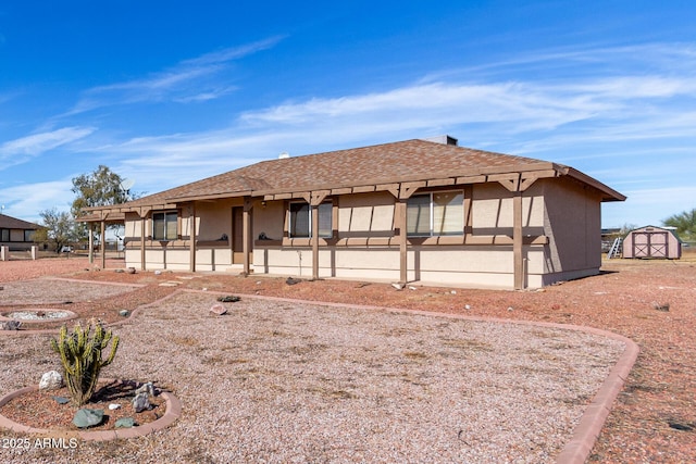 view of front facade with a storage shed and a patio area