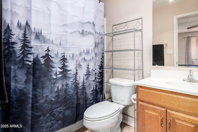 bathroom featuring vanity, a shower with shower curtain, and toilet