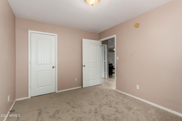 unfurnished bedroom with light carpet