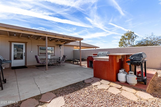 view of patio featuring area for grilling and a grill