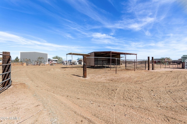 view of yard with an outbuilding and a rural view