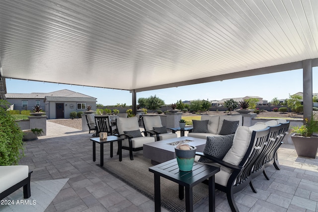 view of patio / terrace with an outdoor living space with a fire pit