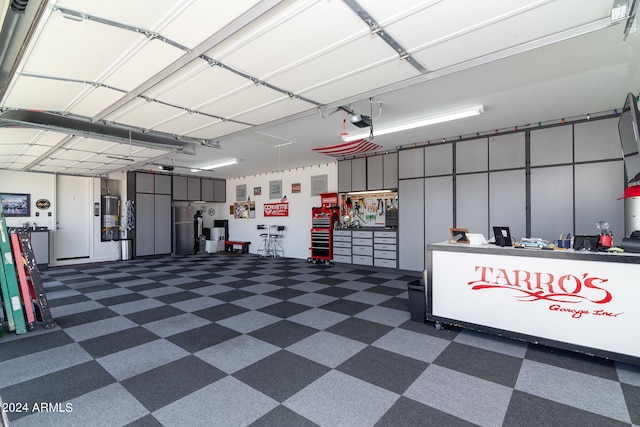 garage with a garage door opener and water heater