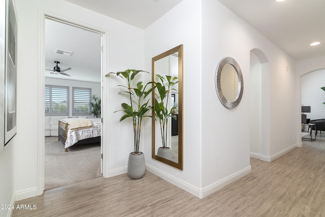 corridor with light hardwood / wood-style flooring