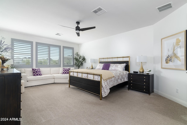 bedroom with ceiling fan and light carpet