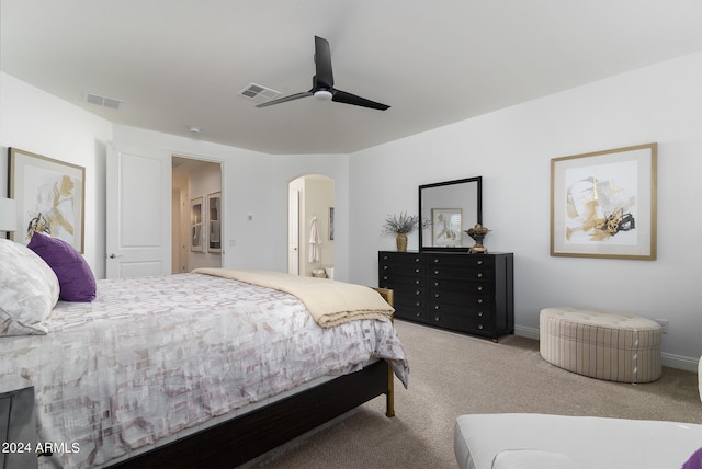 carpeted bedroom featuring connected bathroom and ceiling fan