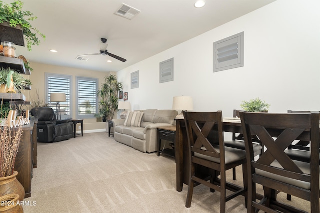 living room with light colored carpet and ceiling fan