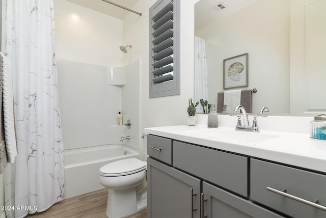 full bathroom featuring shower / tub combo, hardwood / wood-style floors, vanity, and toilet