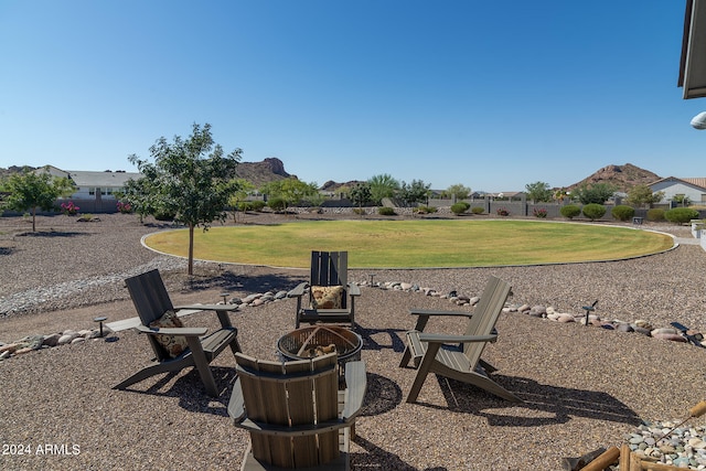 view of yard featuring a fire pit and a mountain view