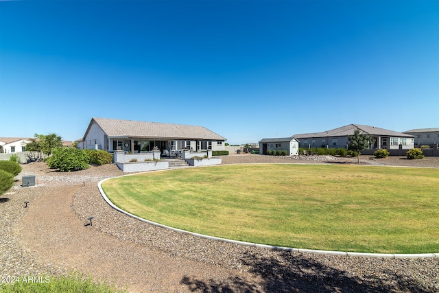 rear view of property featuring a yard