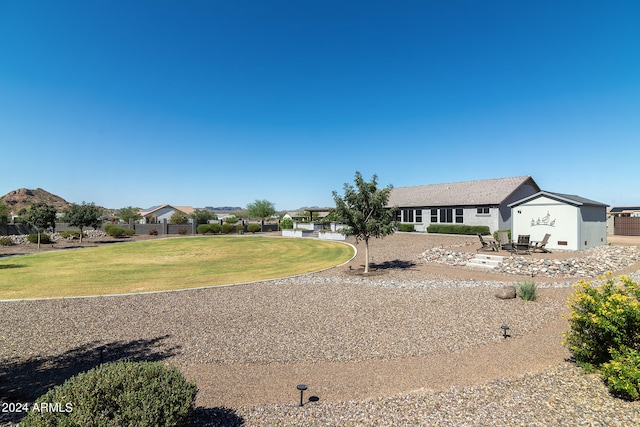 ranch-style home with a front yard and a patio area