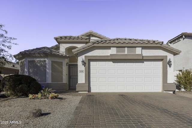 mediterranean / spanish-style home featuring a garage