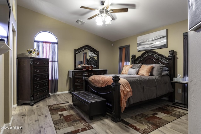 bedroom with ceiling fan, light wood-type flooring, and lofted ceiling