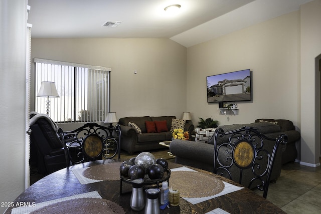 living room featuring tile patterned flooring and lofted ceiling