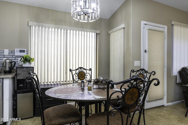 dining space featuring light tile patterned floors and a chandelier