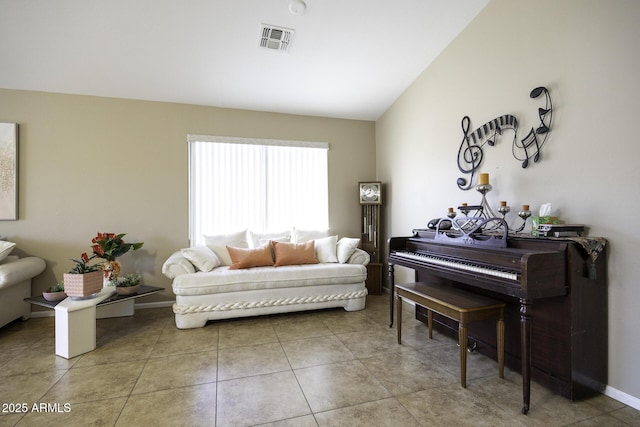 living room with tile patterned floors and lofted ceiling