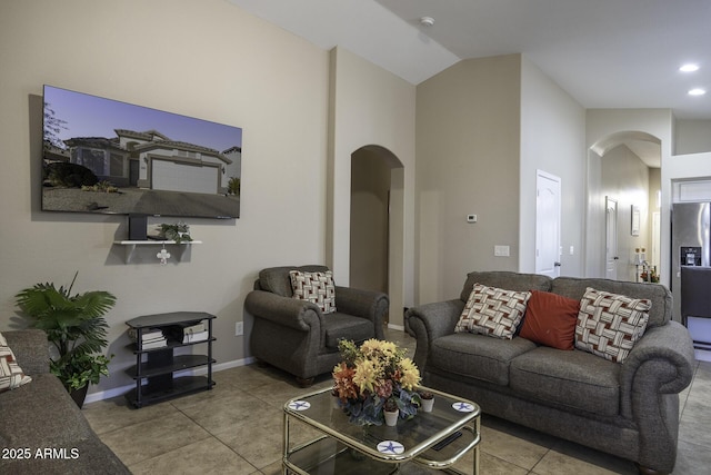 living room with light tile patterned floors and lofted ceiling