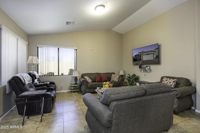 living room with tile patterned flooring and vaulted ceiling