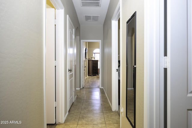 corridor featuring light tile patterned floors