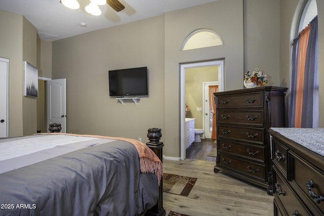 bedroom featuring ensuite bathroom, ceiling fan, and light hardwood / wood-style floors