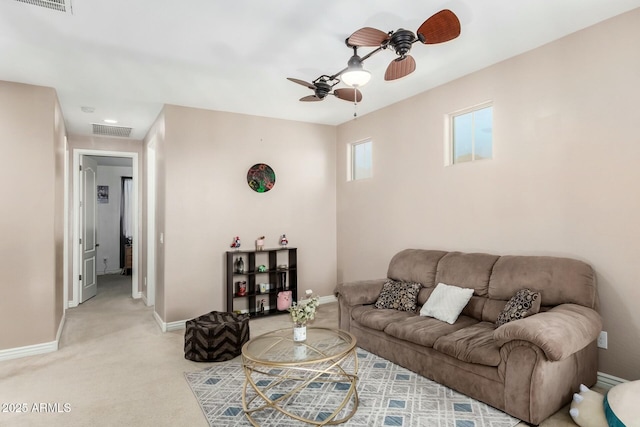 living room featuring light carpet and ceiling fan