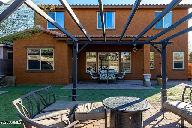 rear view of house featuring a lawn, a patio area, and a pergola