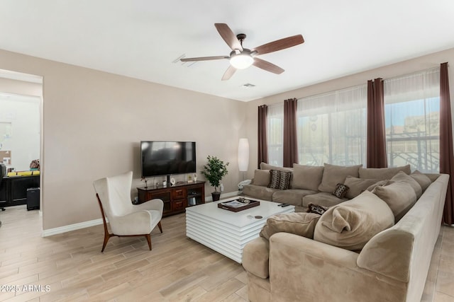 living room featuring ceiling fan and light hardwood / wood-style flooring