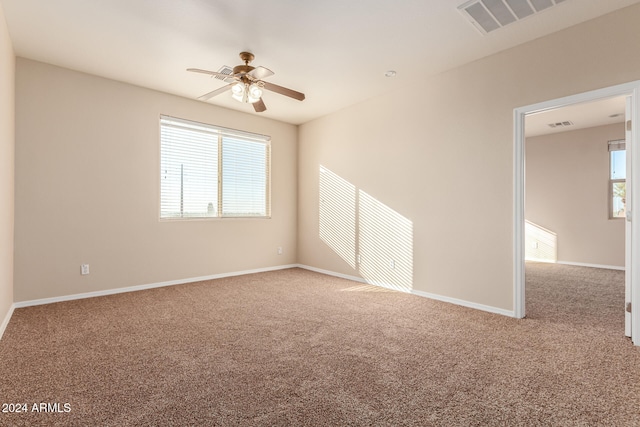 unfurnished room with carpet and ceiling fan