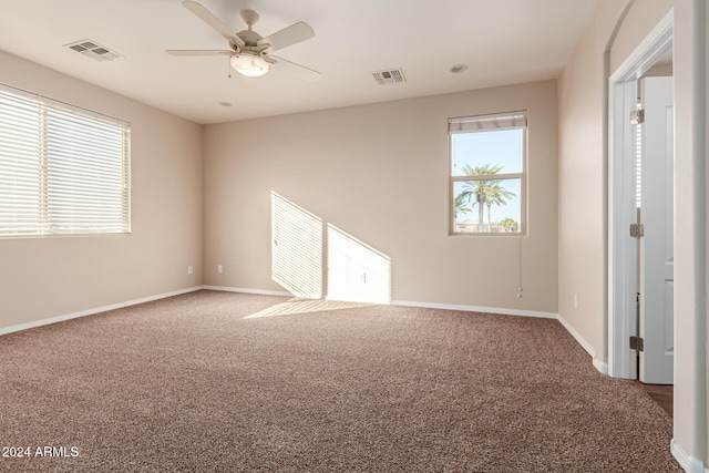 carpeted empty room featuring ceiling fan